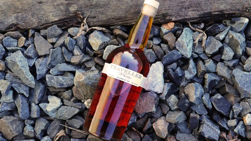 a bottle of buffalo trace traveller whiskey on some rocks