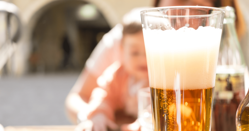 baby behind glass of beer