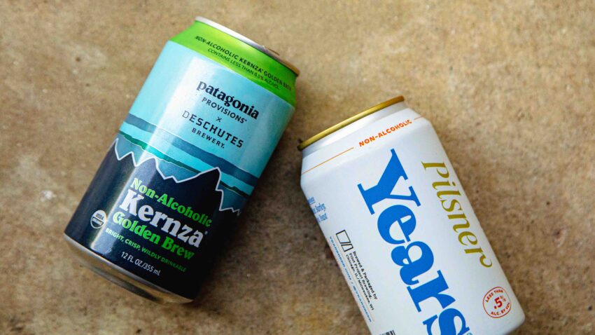 two beer cans on concrete backdrop